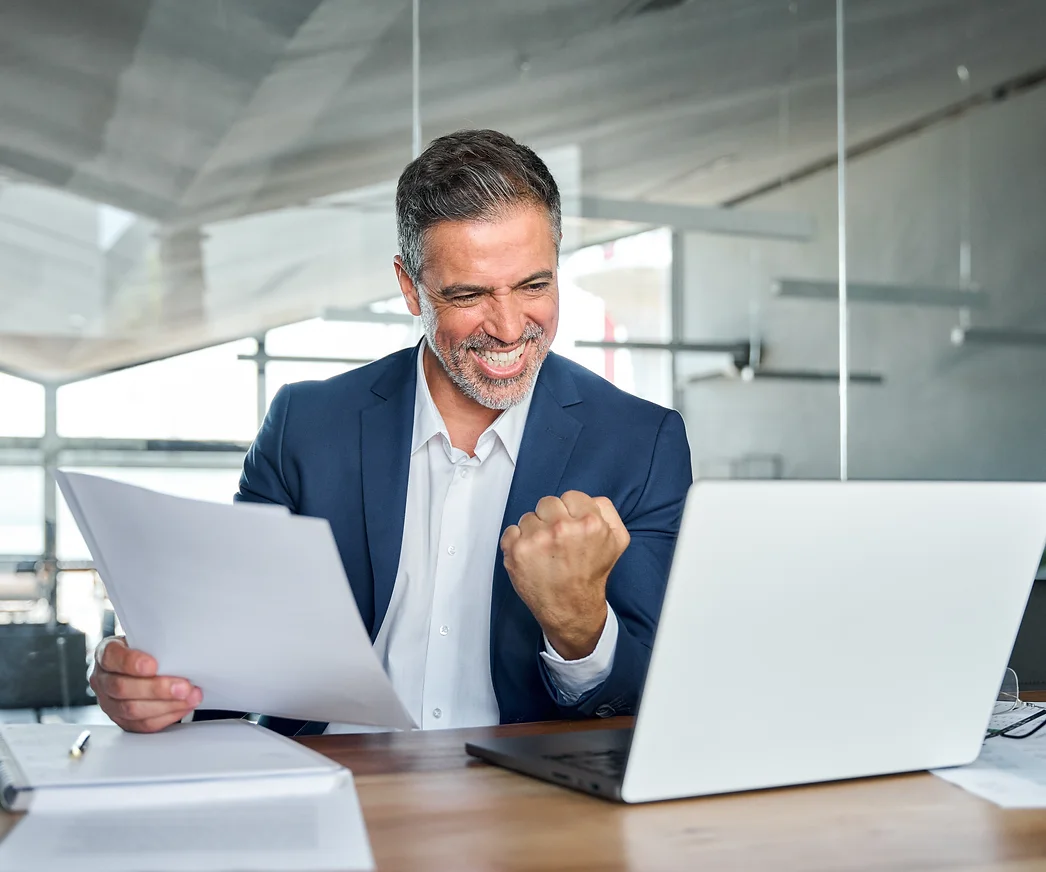 Happy mature older business man ceo wearing suit celebrating success at work in office hol